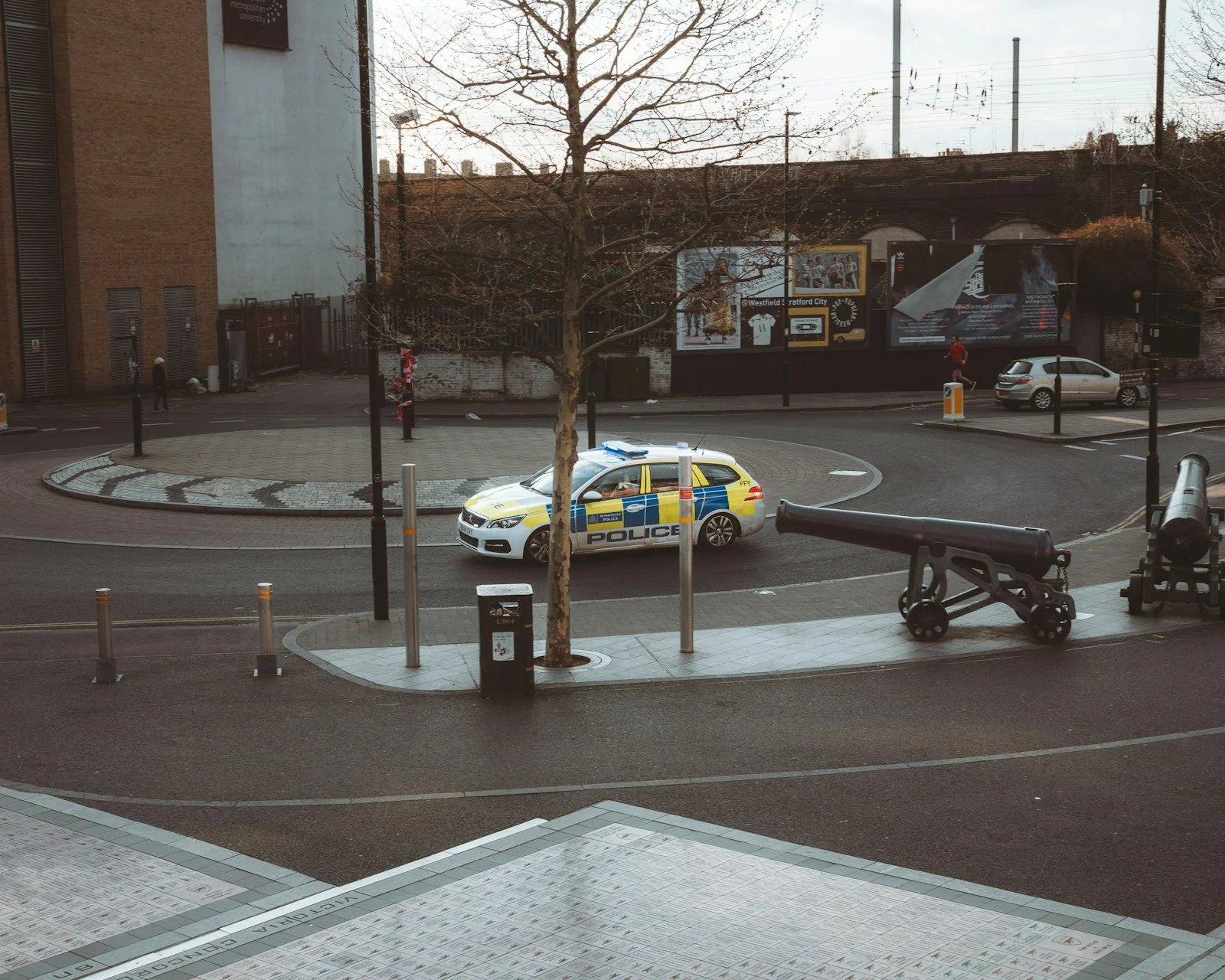 Police car driving around a roundabout with cannons Police car driving around a roundabout with cannons