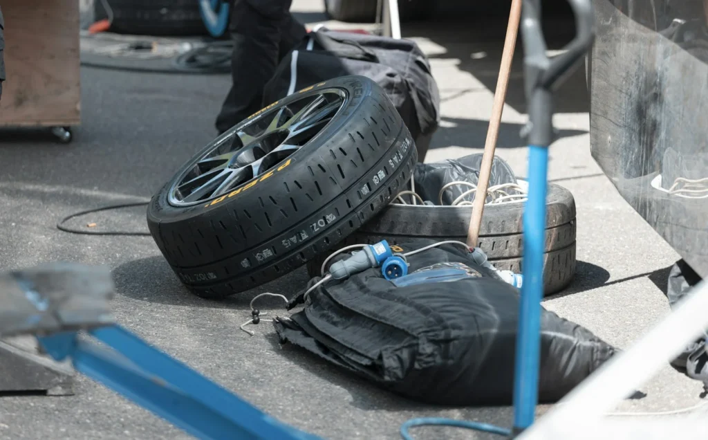 Punctured tyres and wheels on a workshop floor waiting for repair